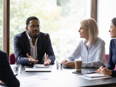 colleagues sitting around a conference table in discussion