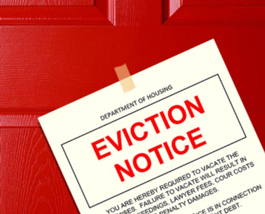 red door with eviction noticed taped to it